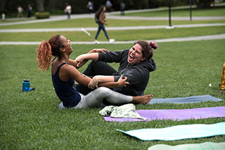 students yoga grass