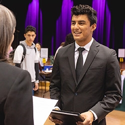 Visitor at career fair interacting with recruiter